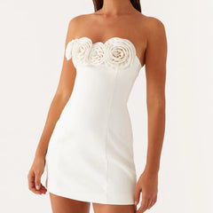 White strapless dress with floral embellishments on a white background