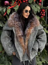 Woman wearing a gray coat with a fur collar in front of a decorated Christmas tree.