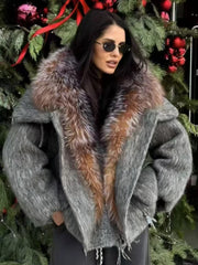 Woman wearing a gray coat with a fur collar in front of a decorated Christmas tree.
