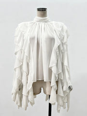 White ruffled top on a mannequin against a white background