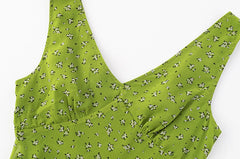 Close-up of the floral print on the green midi dress neckline