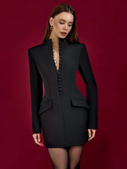 Woman wearing a black blazer dress against a red background