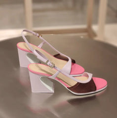 Pink and purple colorblock slingback block heels on a table.