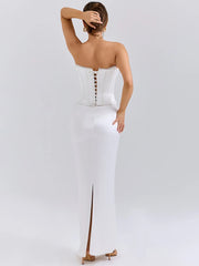 White strapless gown with button detail on a white background