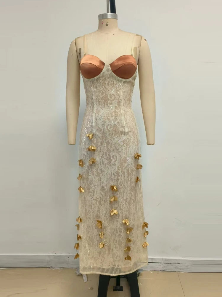 Mannequin wearing a beige lace dress with gold embellishments against a plain background