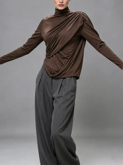Model wearing ruched turtleneck top