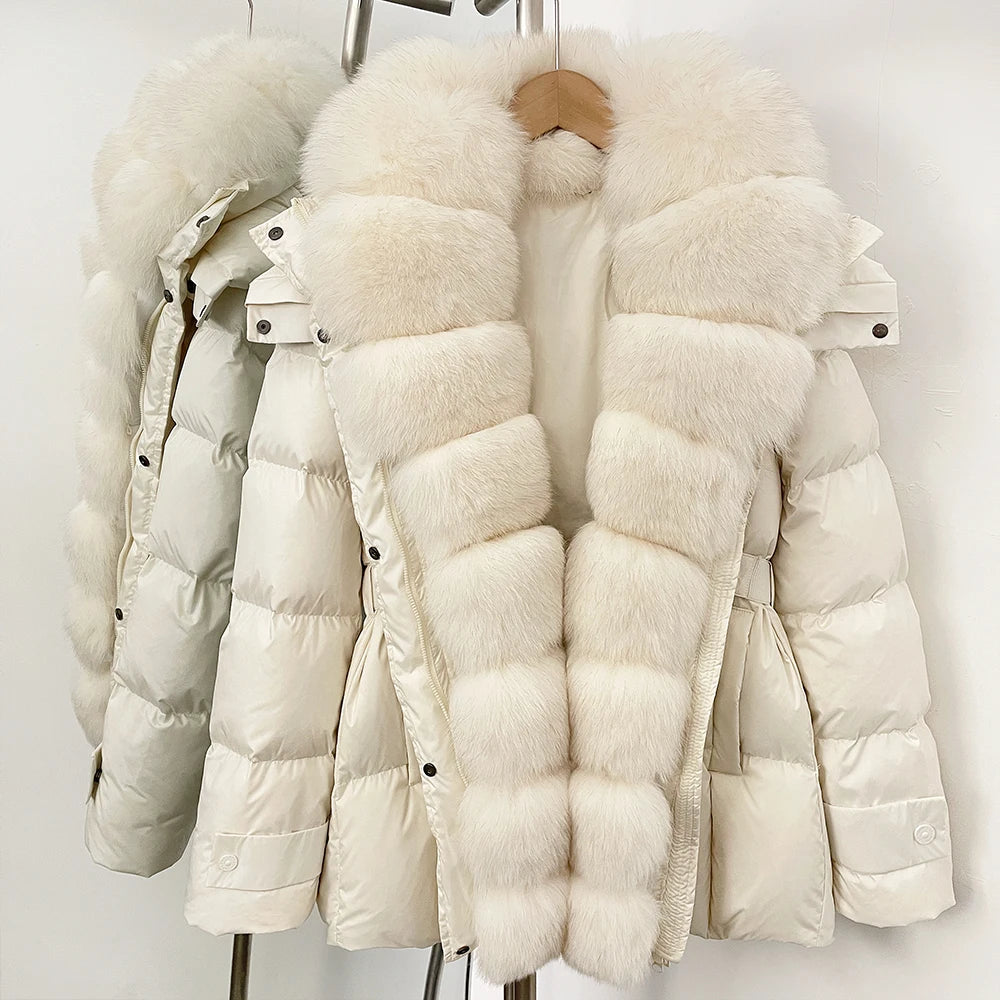 White puffer jacket with fur trim on a rack