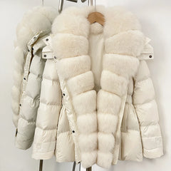 White puffer jacket with fur trim on a rack