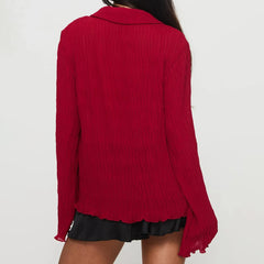 Red blouse worn by a person on a white background