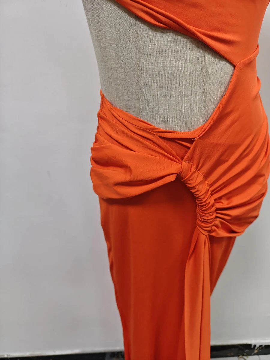 Orange dress on a mannequin against a plain background