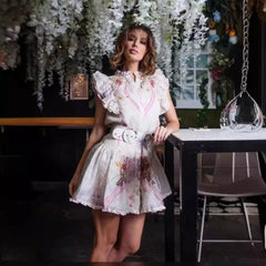 Woman in a floral dress standing in a decorated indoor setting