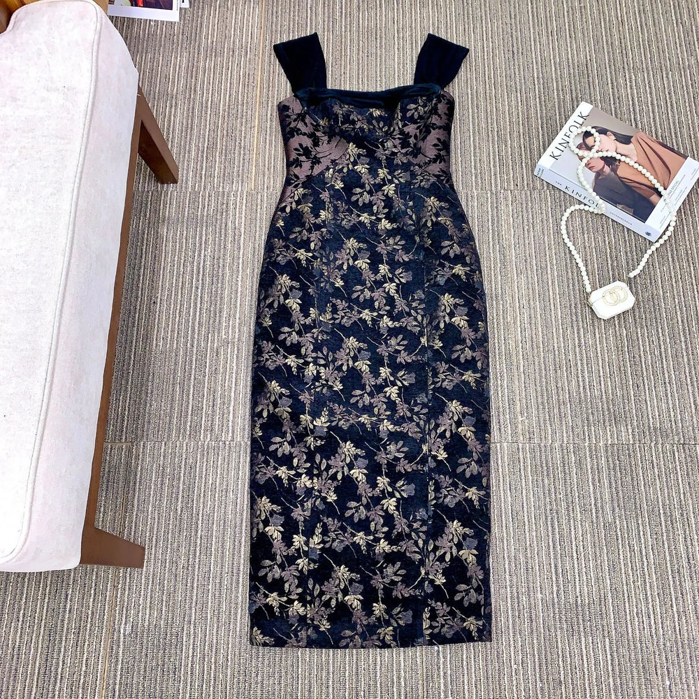 Floral patterned dress on a gray carpet with a magazine and necklace nearby.