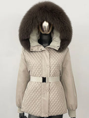 Beige quilted jacket with a large fur hood on a mannequin against a white background