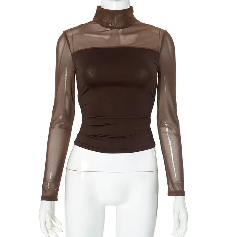 Brown sheer long-sleeve top on a mannequin with white pants against a white background