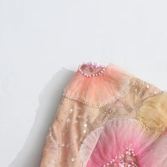 Decorative headpiece with pink and gold colors on a white background
