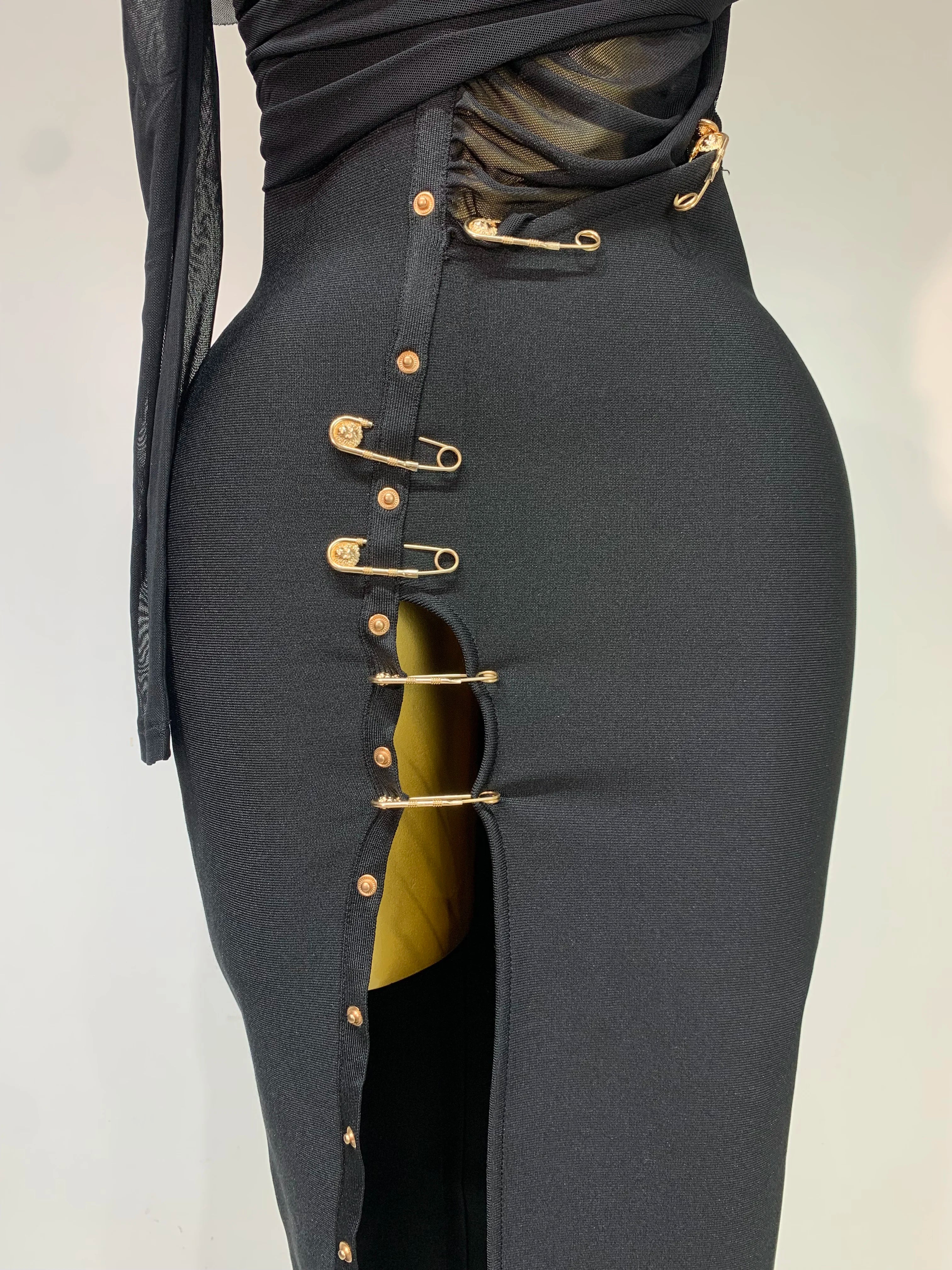 Black skirt with gold buttons on a white background