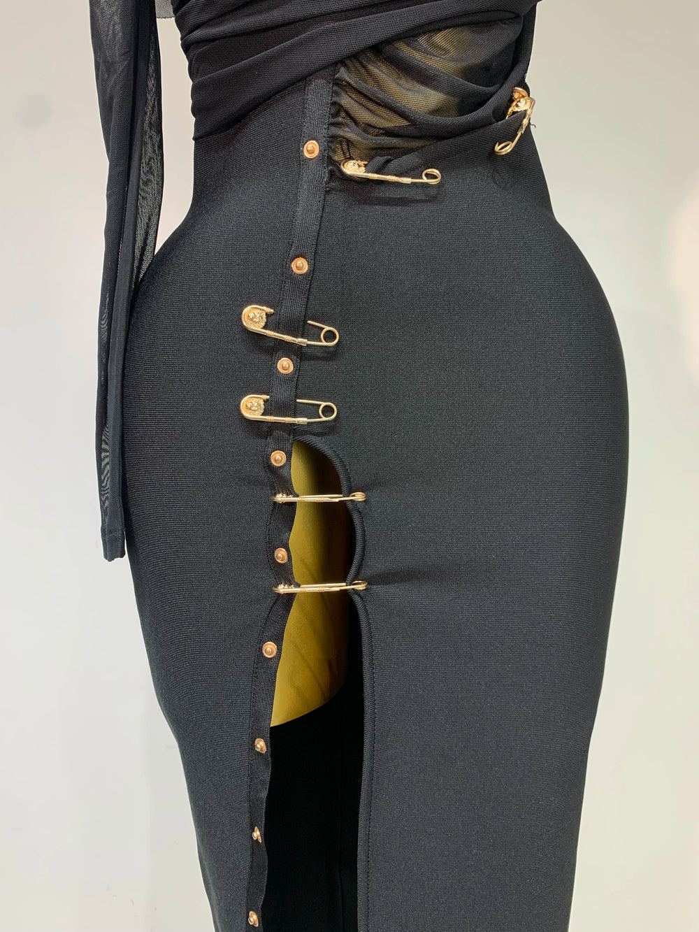 Black skirt with gold buttons on a white background