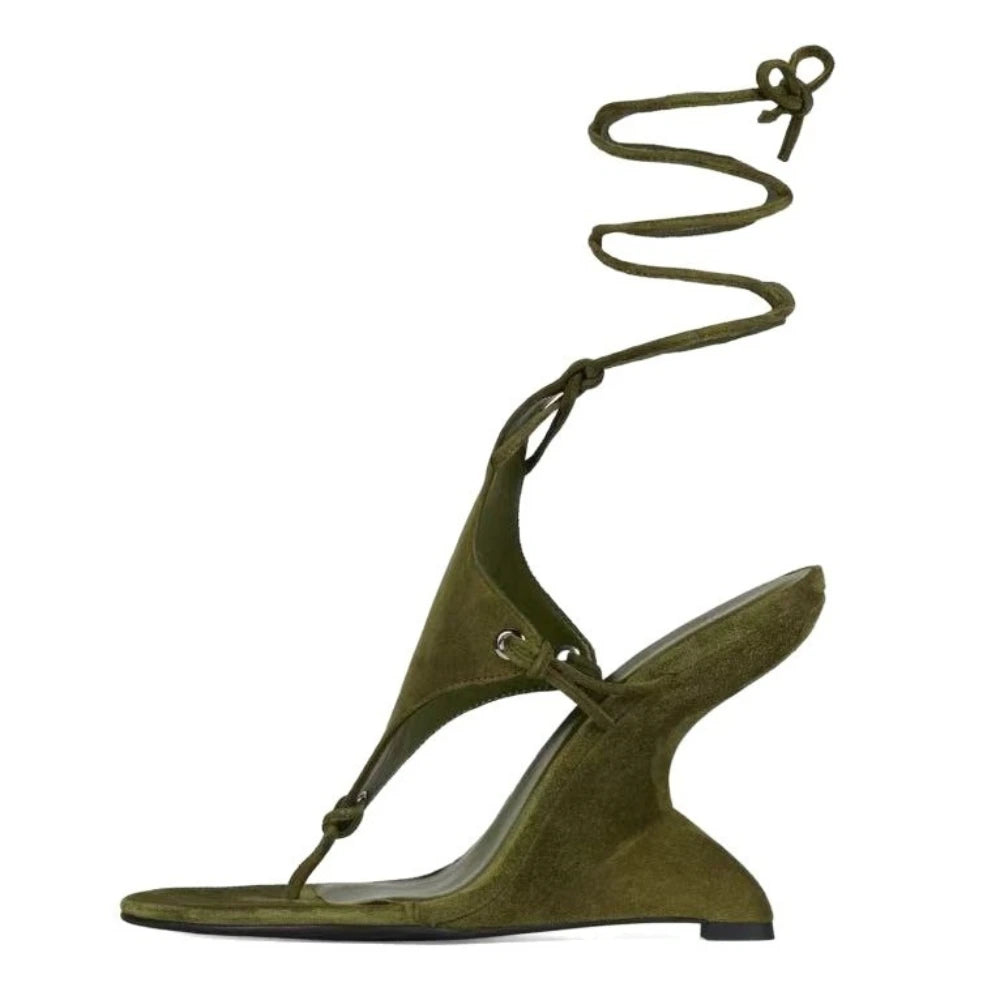 Green sandal with a unique strap design on a white background