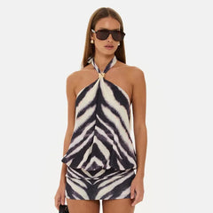 Zebra print halter neck backless mini dress with a form-fitting silhouette.
