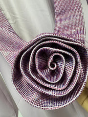 Close-up of a decorative belt with a spiral design and rhinestone embellishments.