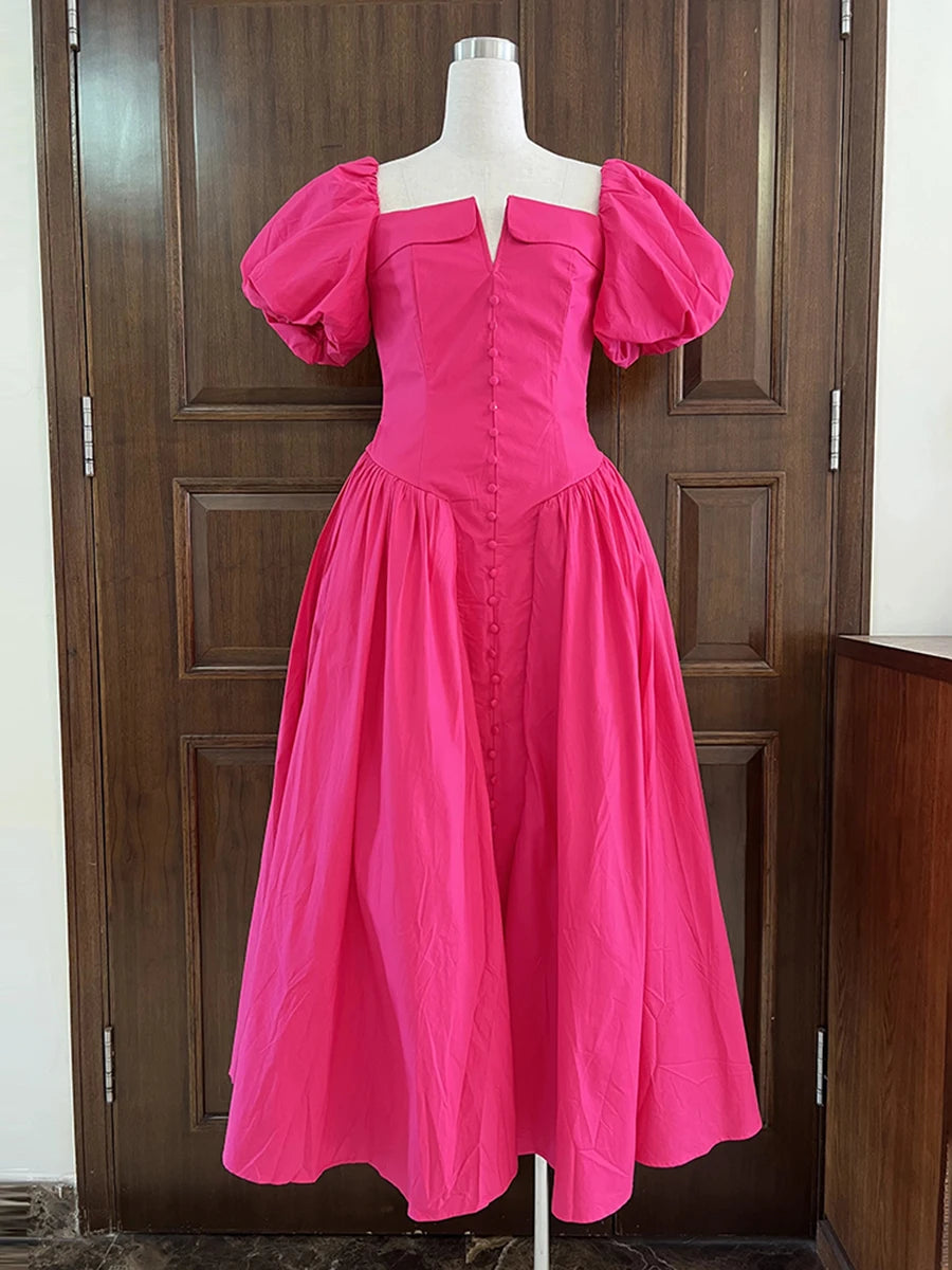 Pink dress on a mannequin against a wooden door background