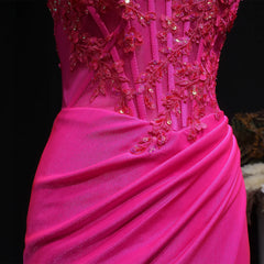 Close-up of a pink evening gown with intricate beadwork on a dark background
