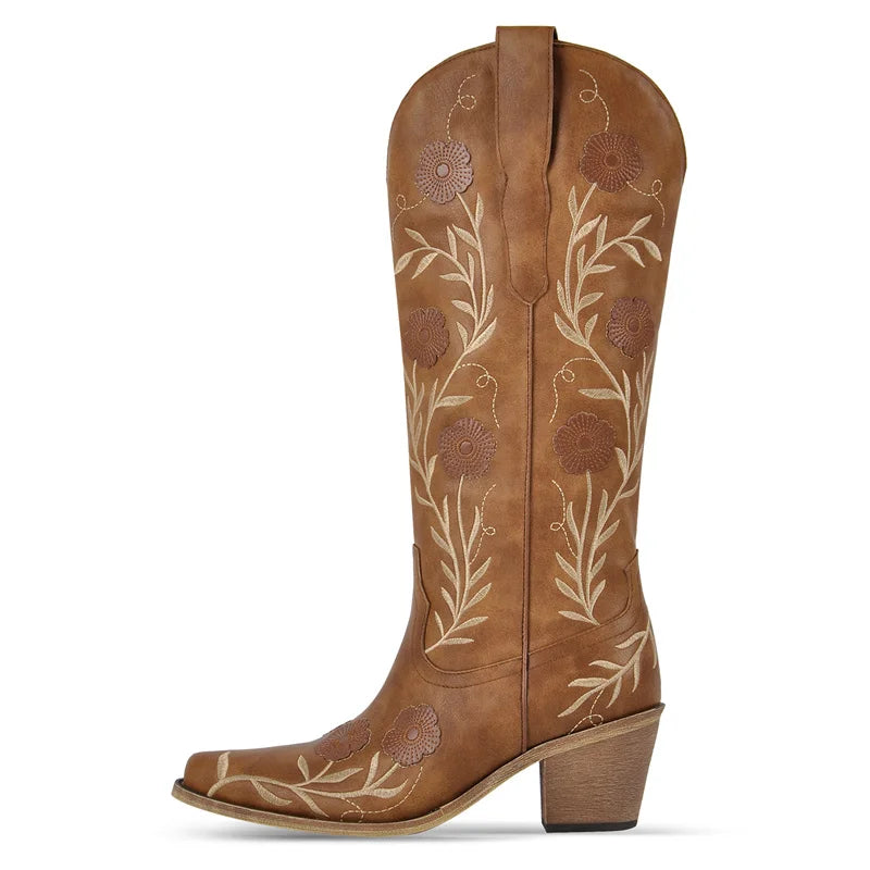 Brown cowboy boot with floral embroidery on a white background