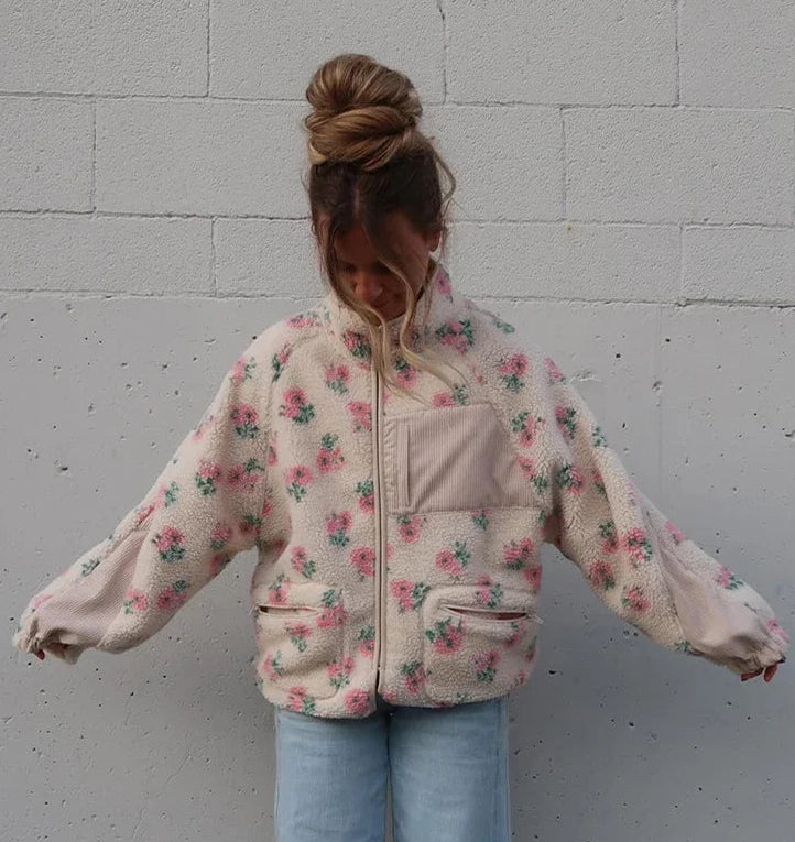 Close-up of the plush fleece texture and floral pattern on the jacket.