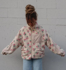 Close-up of the plush fleece texture and floral pattern on the jacket.