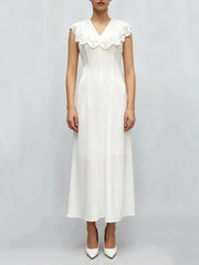 White dress with lace collar on a plain background