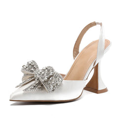 White high-heeled shoe with a decorative bow on a white background