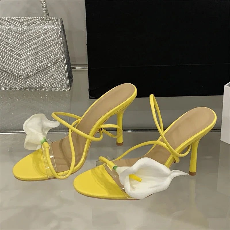 Pair of transparent flower stiletto heels displayed