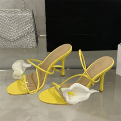 Pair of transparent flower stiletto heels displayed