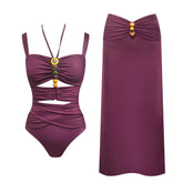 Ruched swimsuit with beaded embellishments and a matching floor-length skirt.