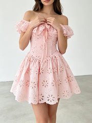 Close-up of the ruffled neckline and eyelet detail on the mini dress