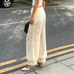Side view of floral lace pants with ruffled cuff