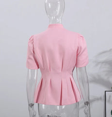 Pink blouse on a mannequin against a light gray background