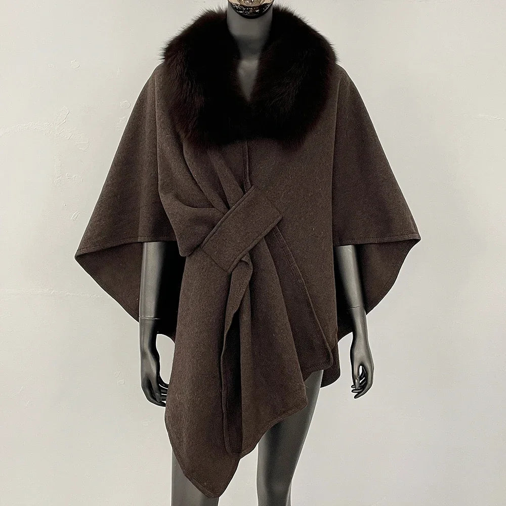 Brown knit poncho with a dark brown fur collar and knotted front.
