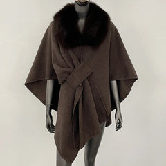 Brown knit poncho with a dark brown fur collar and knotted front.