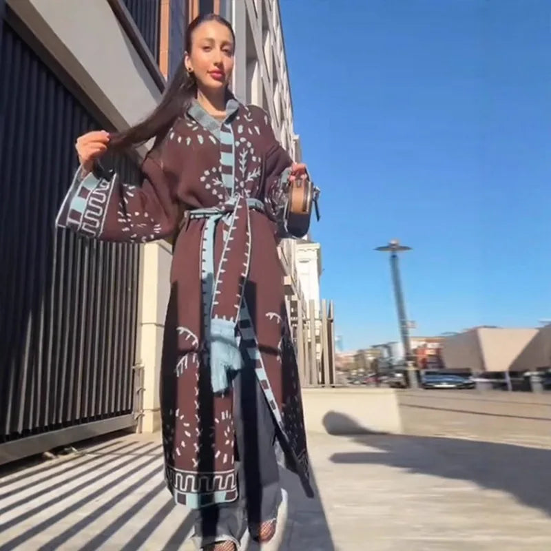 Woman in a patterned outfit standing outdoors on a sunny day.