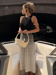 Woman wearing a red and pink ribbed knit midi dress.