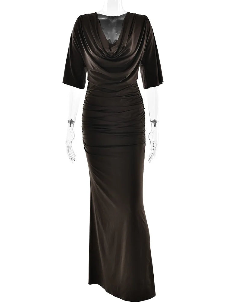 Black evening gown on a mannequin against a white background