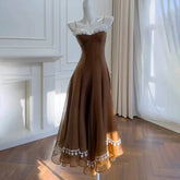 Brown lace-trimmed A-line midi dress on mannequin