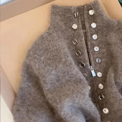 Detail of mock neck zipper button knit top collar
