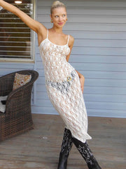 Woman wearing a white lace dress and black boots on a wooden deck.