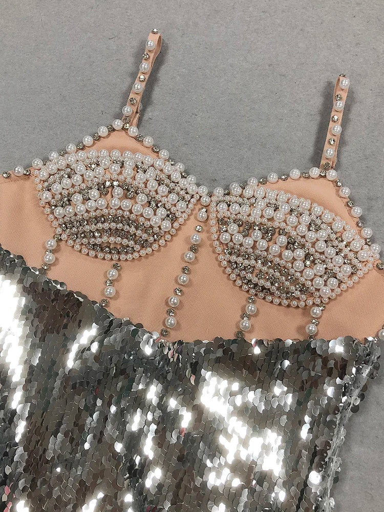 Beaded bralette on a sequin fabric background