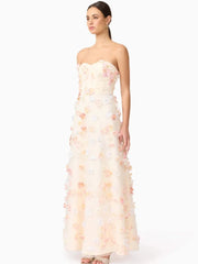 Woman wearing a strapless floral gown on a white background