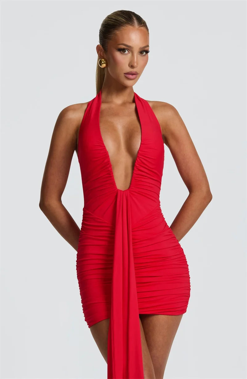 Red halter neck dress with a plunging neckline on a plain background