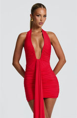 Red halter neck dress with a plunging neckline on a plain background