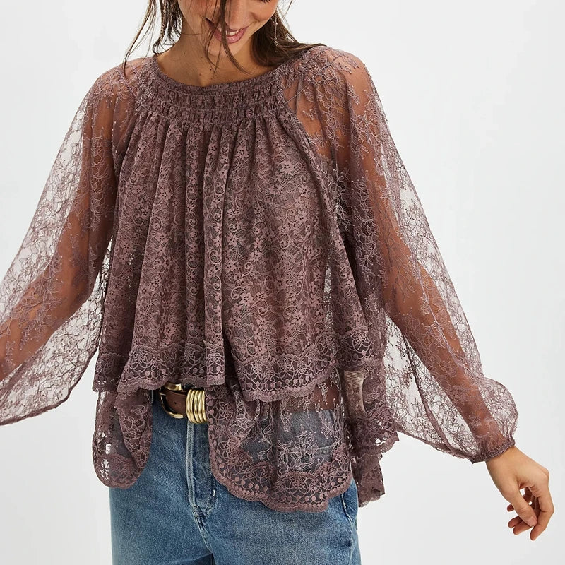 Woman wearing a sheer lace blouse with long sleeves on a white background